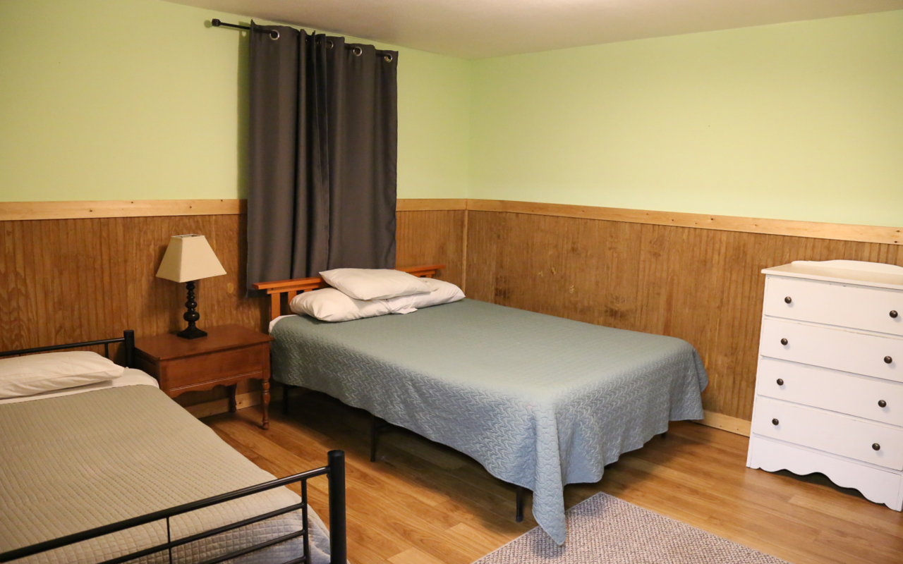 View of bed room with queen bed.