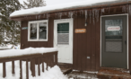 Exterior view of cabin in winter.