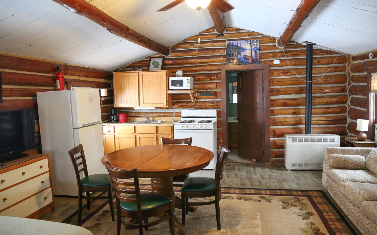 Alternate view of cabin full kitchen with table and chairs.