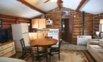 Alternate view of cabin full kitchen with table and chairs.