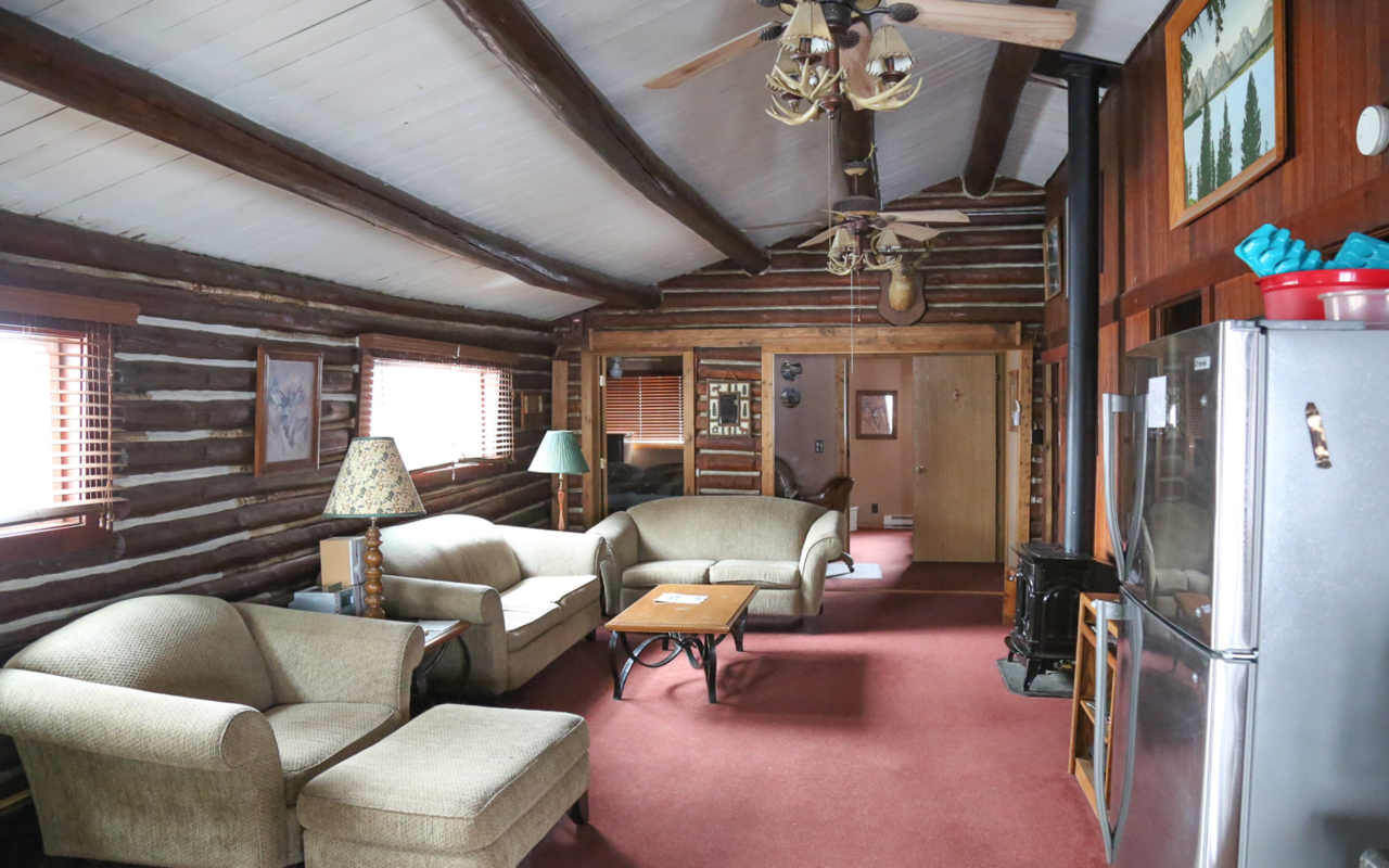 Interior cabin view of living room facing two bedrooms.