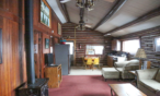 Interior cabin view of living room, kitchen and eating area.