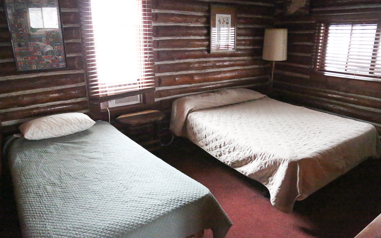 Interior cabin view of bedroom with two twin beds.