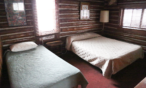Interior cabin view of bedroom with two twin beds.