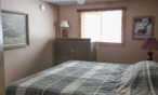 Interior cabin view of queen bedroom.