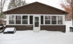 Exterior view of four-bedroom cabin in winter.