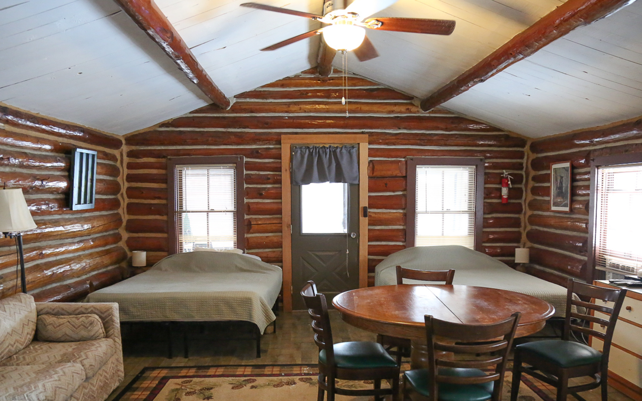 Long view of the cabin looking towards the door and the two queen beds.
