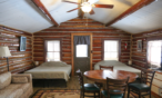 Long view of the cabin looking towards the door and the two queen beds.