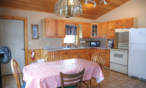 Interior cabin view of kitchen and eating areas.
