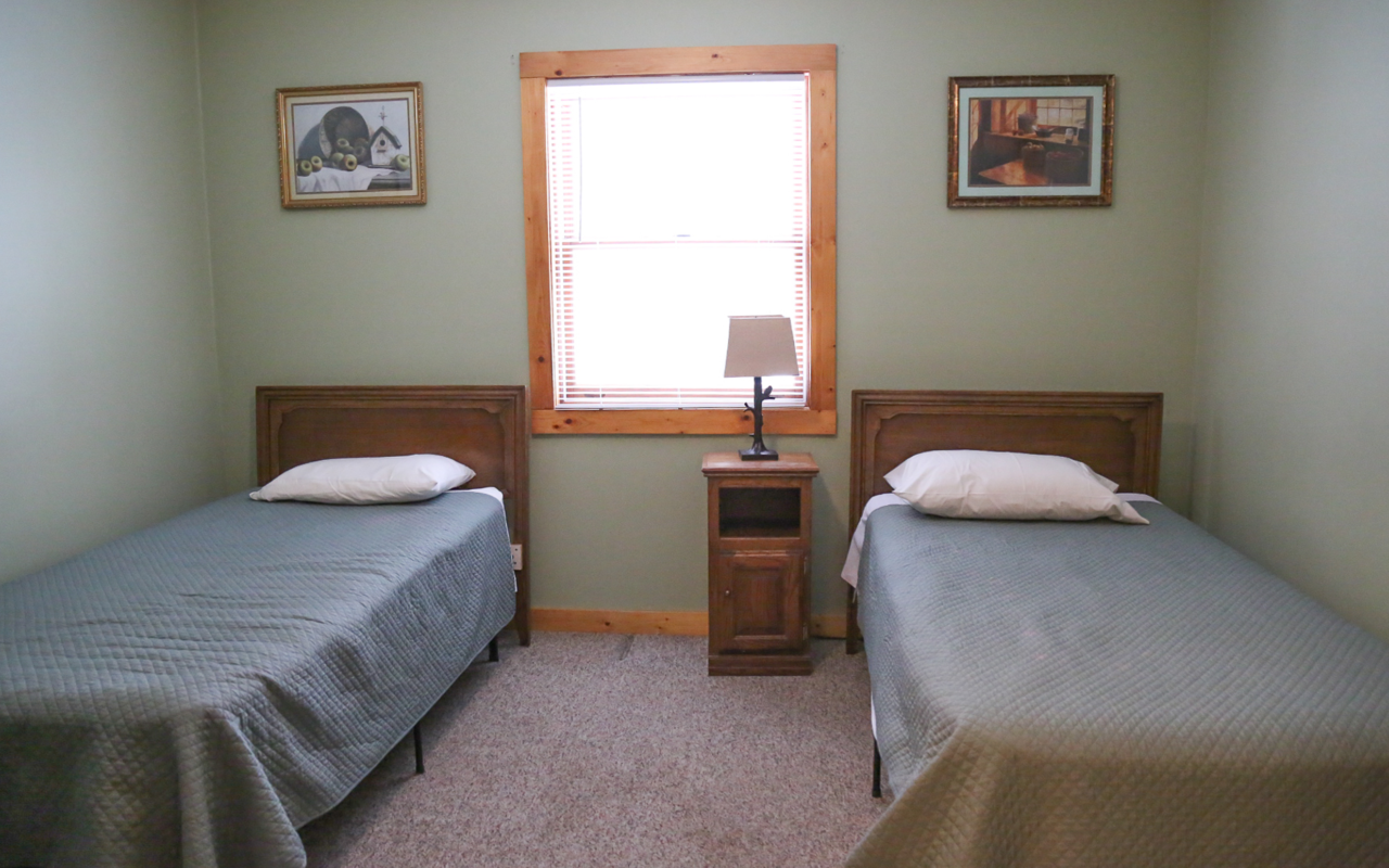 Interior cabin view of bedroom with two twin beds.