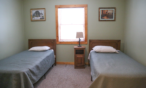Interior cabin view of bedroom with two twin beds.