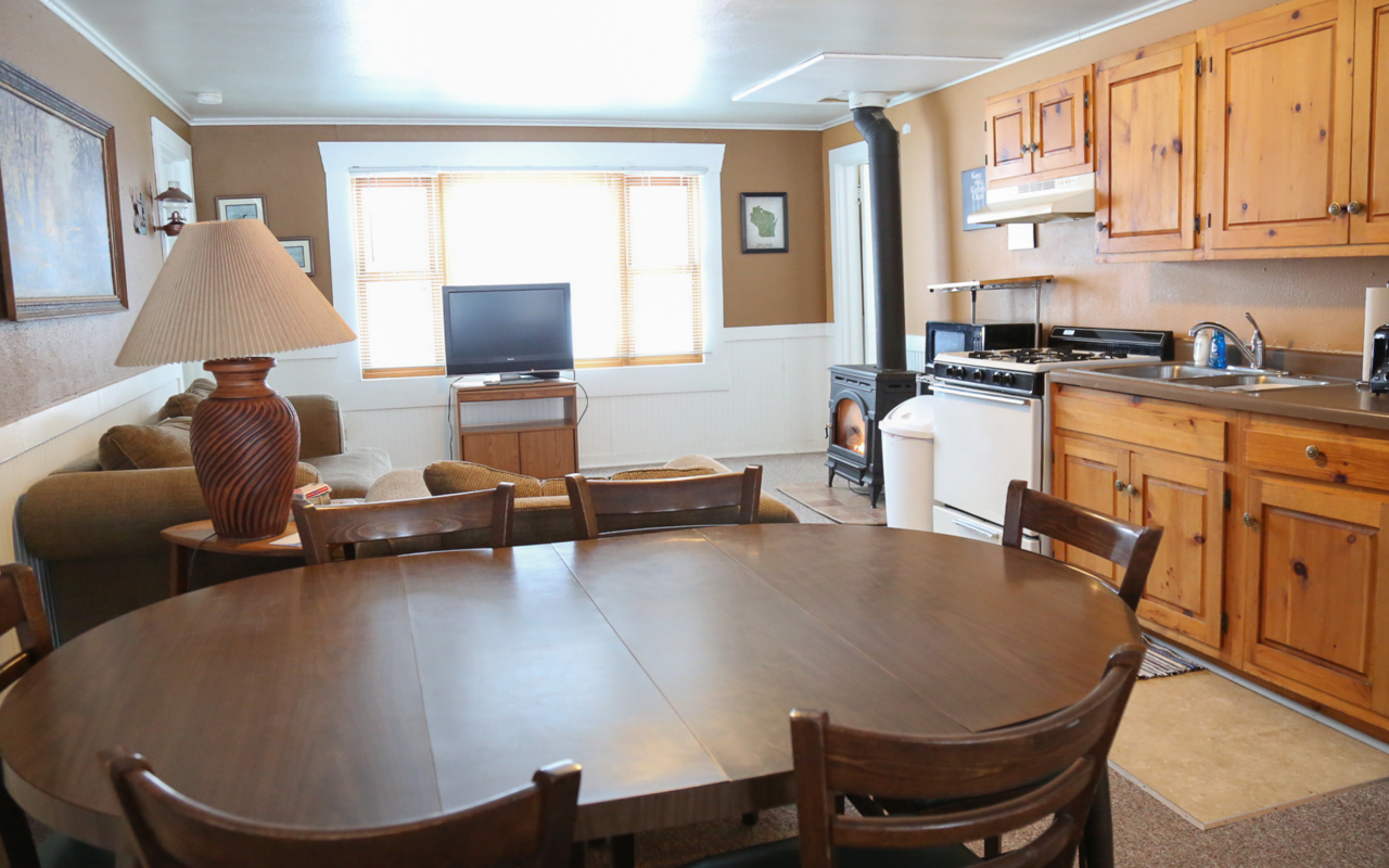 Interior cabin view of kitchen and eating areas.