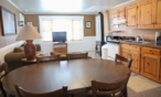 Interior cabin view of kitchen and eating areas.