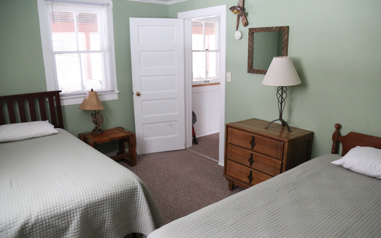 Interior cabin view of bedroom with two beds.