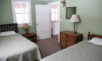 Interior cabin view of bedroom with two beds.