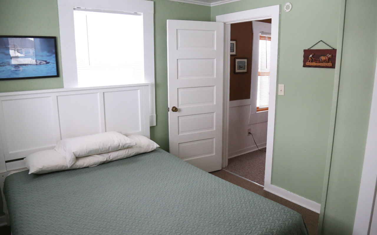 Interior cabin view of one queen bed.