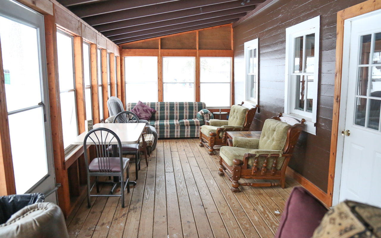 View of screened in porch with sitting area.