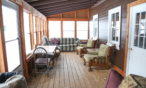 View of screened in porch with sitting area.