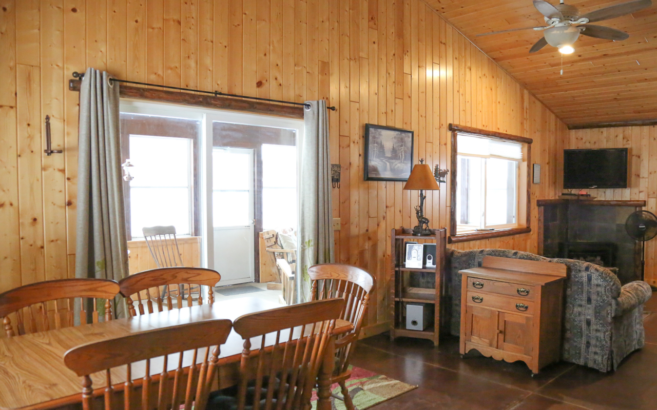 Cabin interior view of dining table and sitting area.