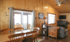 Cabin interior view of dining table and sitting area.