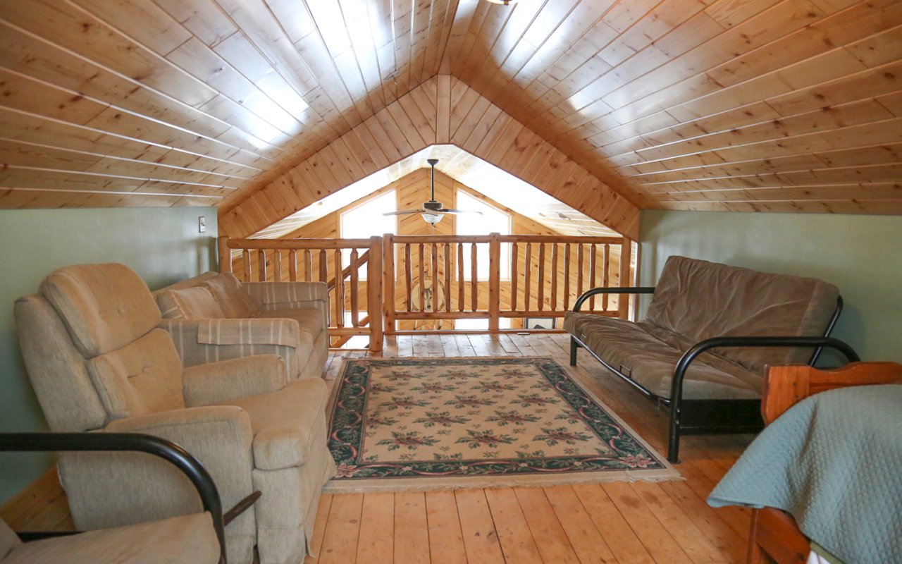 Interior cabin view of loft facing the stairway.