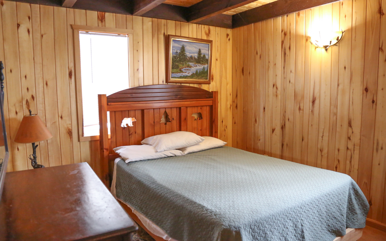 Interior cabin view of bedroom two with queen bed.