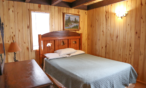 Interior cabin view of bedroom two with queen bed.